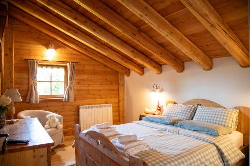 a bedroom with a bed in a wooden room at Baita dei Fovi in Baselga di Pinè