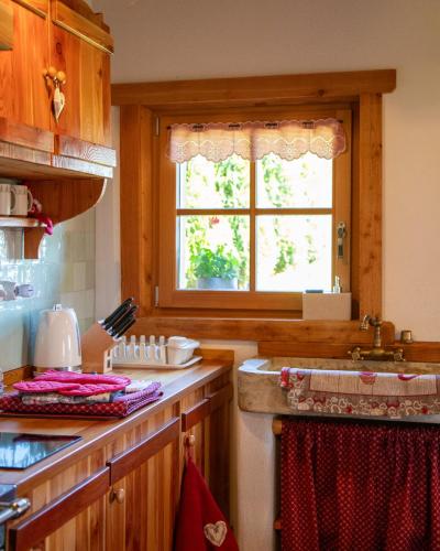 a kitchen with a sink and a window at Baita dei Fovi in Baselga di Pinè