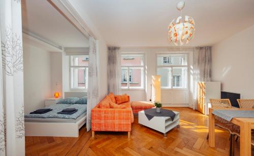 a living room with a bed and a couch at Haus Spiegel - Cramergasse, Lindau Insel in Lindau