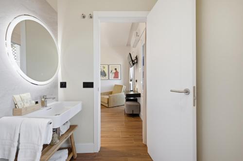 a bathroom with a sink and a mirror at Pardavila 57 Slow Hotel in Marín