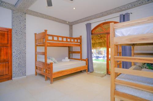 a room with two bunk beds and a ladder at Las Golondrinas KM59 in Taquillo