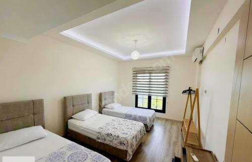 a bedroom with two beds and a skylight at Seyran Seaside Apartments - 2-dublex in Trabzon