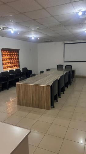 a conference room with a large table and chairs at NBTE Hotels in Kaduna
