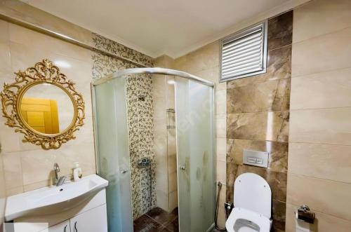 a bathroom with a shower and a toilet and a sink at Seyran Seaside Apartments - 2-dublex in Trabzon