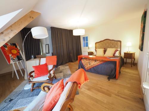 a room with a bedroom with a bed and a couch at MAISON d HOTES in May-sur-Orne