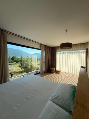 a bedroom with a large bed and a large window at Vico Suite in Santa Maria a Vico