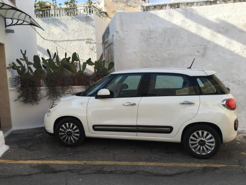 a white car parked in a parking lot at B & B Sotto la Volta in Massafra
