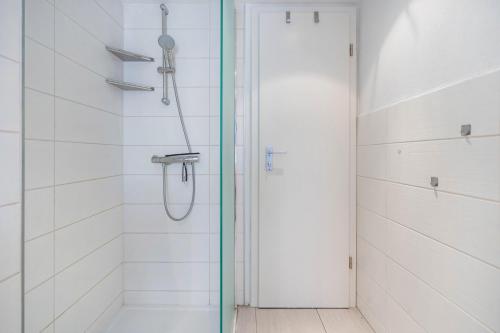 a shower with a glass door in a bathroom at Ankerhaus 2 in Trent