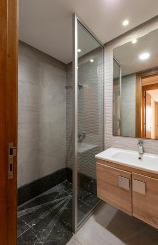 a bathroom with a sink and a shower at Comfort and luxury with pool in Tamaris