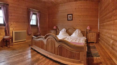 a bedroom with a large bed in a log cabin at Almhütte Gipper in Heiligenblut