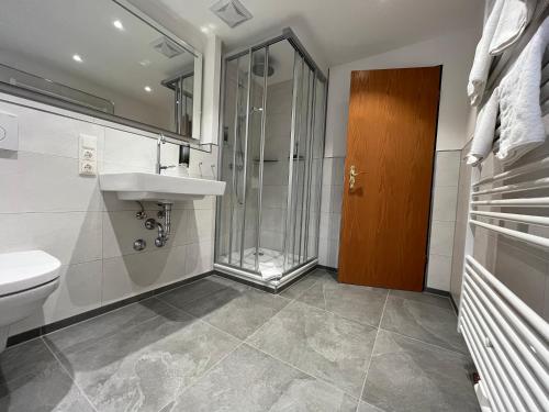 a bathroom with a shower and a sink and a toilet at BSW Hotel Hubertus-Park in Schönau am Königssee