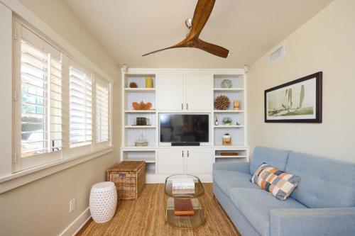 a living room with a blue couch and a tv at Playa One Bedroom (251) in Carpinteria