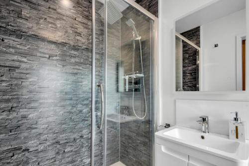 a bathroom with a glass shower and a sink at Larkey View A Tranquil Space For Two - Pass the Keys in Canterbury