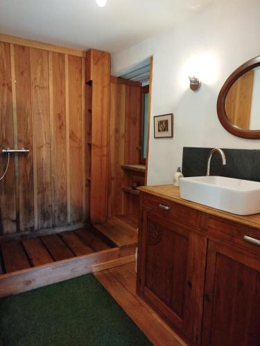 a bathroom with a tub and a sink and a shower at La Bouriotte Gîtes in Labastide-Rouairoux
