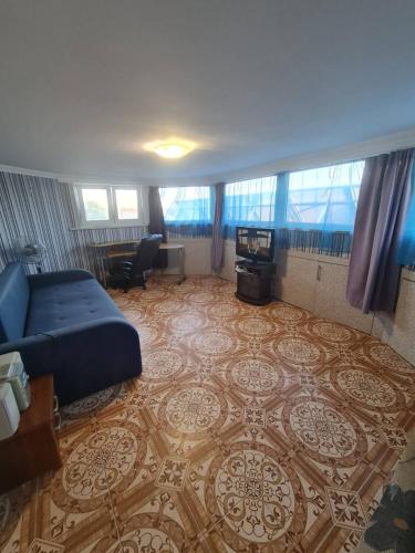 a bedroom with a bed and a living room at Apartment on Demenchuka 19 in Fontanka