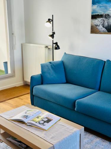 a blue couch in a living room with a coffee table at Blue Harmony in Massy
