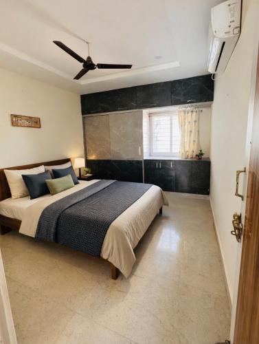 a bedroom with a bed and a ceiling fan at Gayathri Residency premium 2bhk in Hyderabad