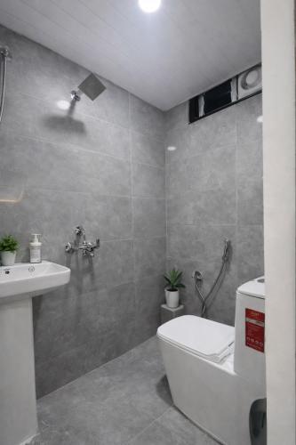 a bathroom with a toilet and a sink at Gayathri Residency premium 2bhk in Hyderabad