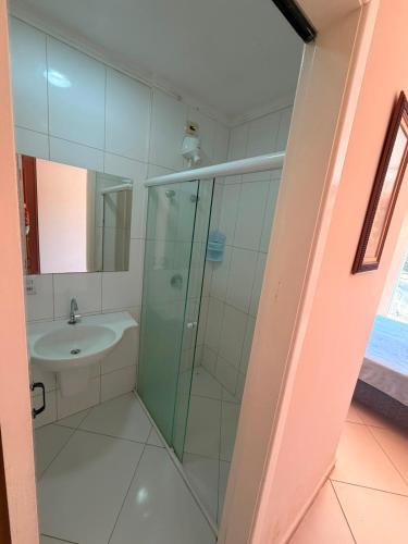 a bathroom with a shower and a sink at Hotel Canaã Express in Jarinu