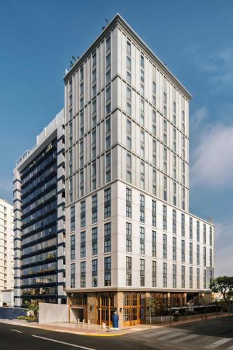 a tall white building on the corner of a street at Humano, Lima, a Tribute Portfolio Hotel in Lima