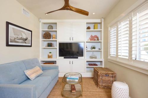 a living room with a blue couch and a tv at Playa One Bedroom (253) in Carpinteria