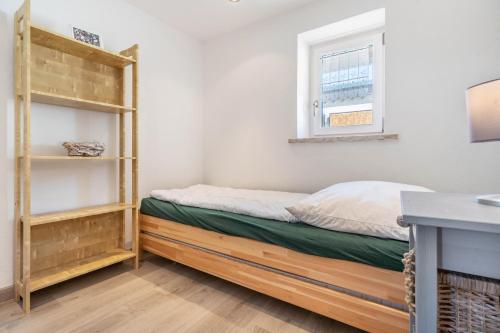 a small bedroom with a bed and a window at Ankerhaus 2 in Trent