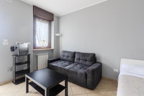 a living room with a couch and a table at Turin Airport apt G in Leinì