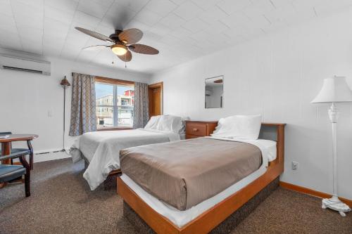 a bedroom with two beds and a ceiling fan at Echo Motel in Old Orchard Beach