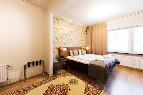 Säng eller sängar i ett rum på SPiS Hotell Naran