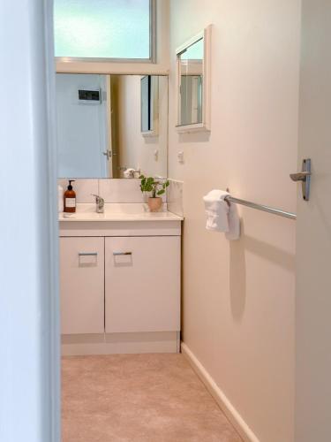 a bathroom with a sink and a mirror at Cozy & Spacious Family Unit Mt Martha in Mount Martha