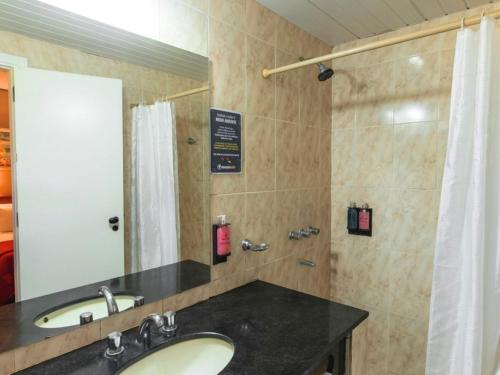 a bathroom with a sink and a shower at Marcopolo Suites Iguazu in Puerto Iguazú