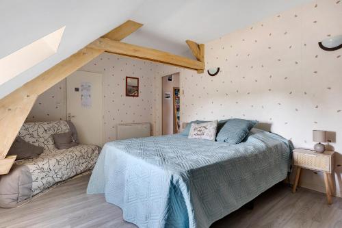 a bedroom with a bed and a couch in it at Lorali - Chambre d'Hôtes in Gohier