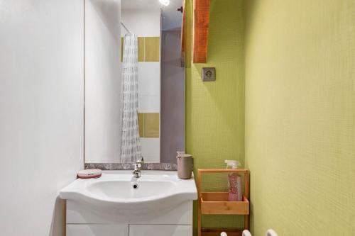 a bathroom with a white sink and a mirror at Lorali - Chambre d'Hôtes in Gohier