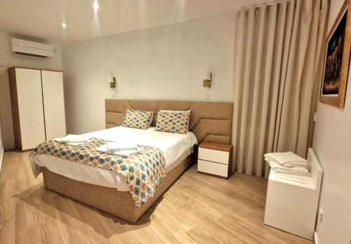 a hotel room with a bed and a window at Cidadela do Viriato in Viseu