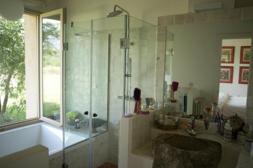 a bathroom with a shower and a tub and a sink at Finca El Ropero Eco-friendly house in Villanueva de la Vera