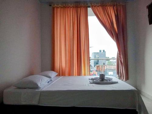 a bed in a room with a window and aucerasteryasteryasteryasteryastery at hotel brb nature acacias in Acacías