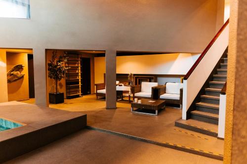 a living room with a staircase and a dining room at Esplendor by Wyndham El Calafate in El Calafate