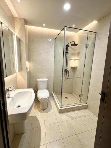 a bathroom with a shower and a toilet and a sink at AERON hotel in Yakkasaray
