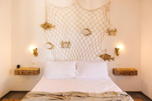 a bedroom with a bed with a headboard with spiders on the wall at Appartamento Sea - Tenuta Fascianello in Fasano