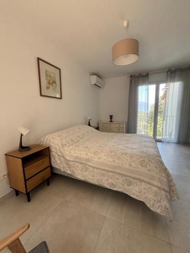 a bedroom with a bed and a table and a window at Casa Mezzana in Valle-di-Mezzana