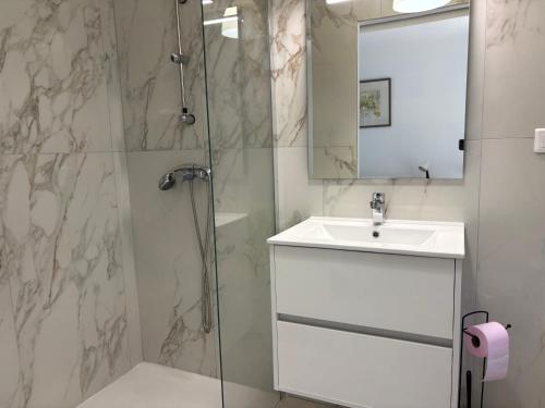 a bathroom with a shower and a sink and a mirror at Casa Mezzana in Valle-di-Mezzana