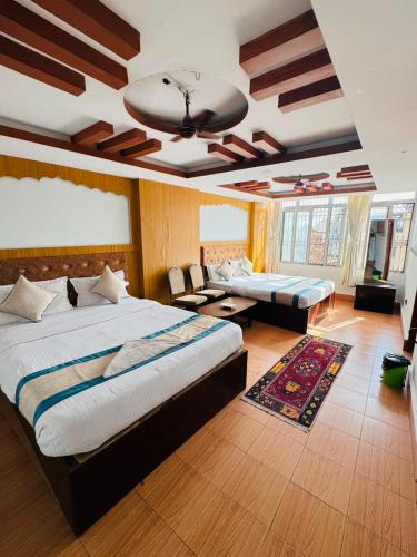 a large bedroom with two beds and a couch at Hotel Delite in Thapathali