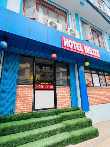 a hotel deluxe with stairs leading into the door at Hotel Delite in Thapathali