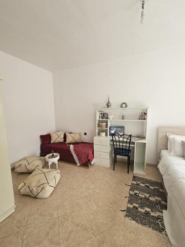 a living room with a couch and a table at Pearl studio avec terrasse in Larache