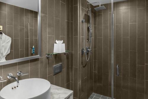 a bathroom with a shower and a sink at Four Points by Sheraton New York Downtown in New York