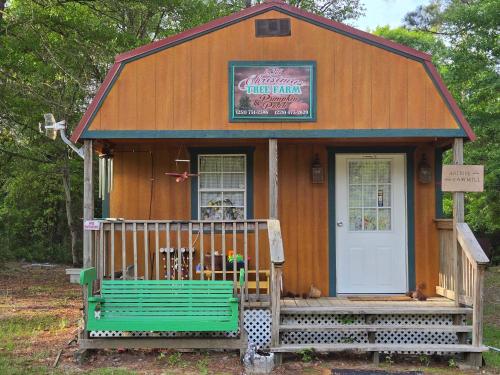 a small house with a bench in front of it at Whippowill Cabin in Moss Point