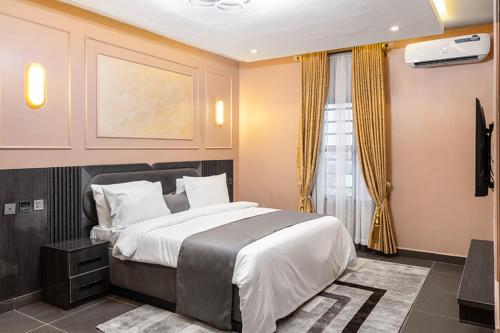 a bedroom with a large bed and a window at BON Hotel Emporium in Ughelli