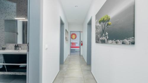 a hallway with a bathroom with a sink and a mirror at Villa Stella by LovelyStay in Arco da Calheta