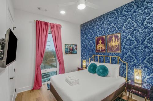a bedroom with a bed and a blue wall at Tiger Lily in Nashville
