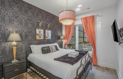 a bedroom with a bed and a large window at Tiger Lily in Nashville